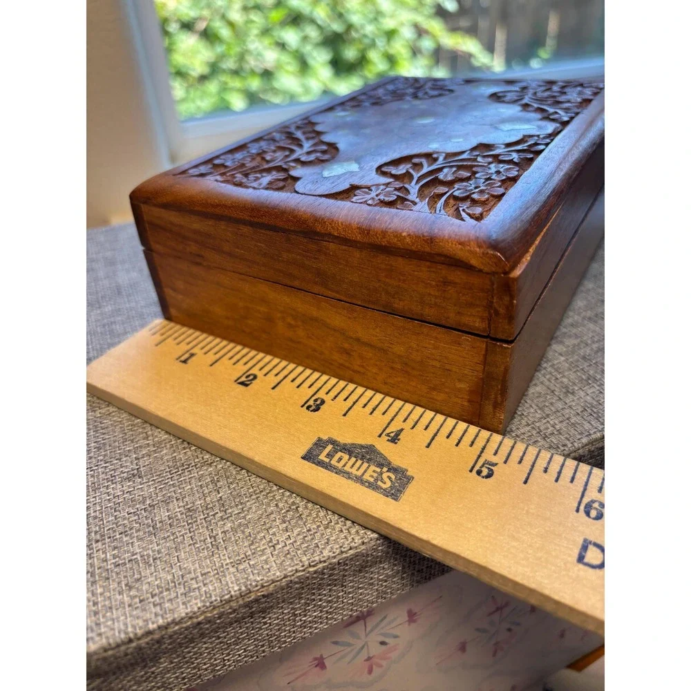Handmade wooden jewelry box with a brass inlay and hand-carved floral design